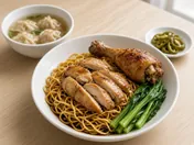 Chicken wantan mee: egg noodles in dark sauce topped with sliced glazed chicken, a roasted chicken drumstick and choy sum, with a small bowl of wantan soup and pickled green chillies