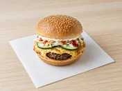 Malaysian street burger: beef patty wrapped in thin fried egg in a toasted sesame roll with cabbage, cucumber, mayonnaise and chilli sauce