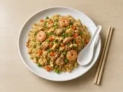 Yang chow fried rice with prawns, chicken, peas, carrot and egg on a white plate